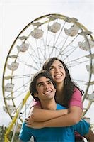 Guy and girl with ferris wheel in background