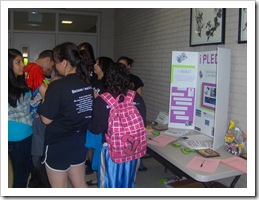 Kids Standing In front of a presentation table